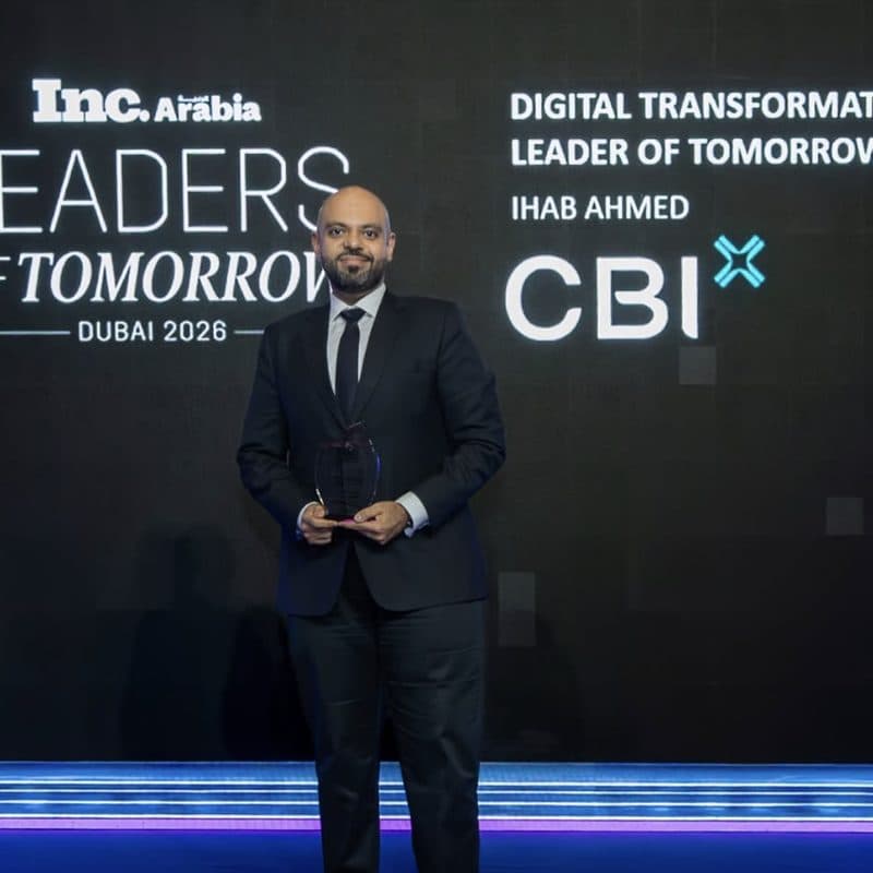Ihab Ahmed on stage holding the Inc. Arabia Leaders of Tomorrow trophy