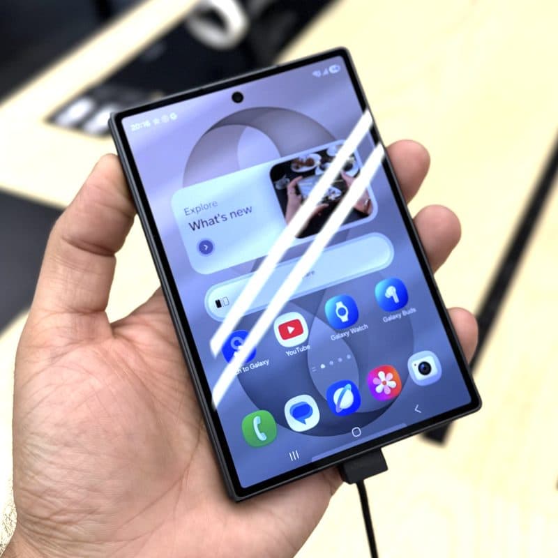 Samsung Galaxy foldable held open in one hand, home screen showing